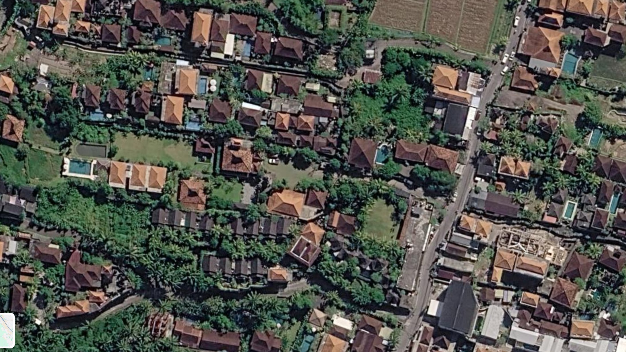 The same block near Ubud in 2026, covered by villa roofs, pools and paved terraces